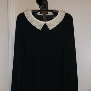 Black crew neck sweater w/ pearl detail 100% wool.
